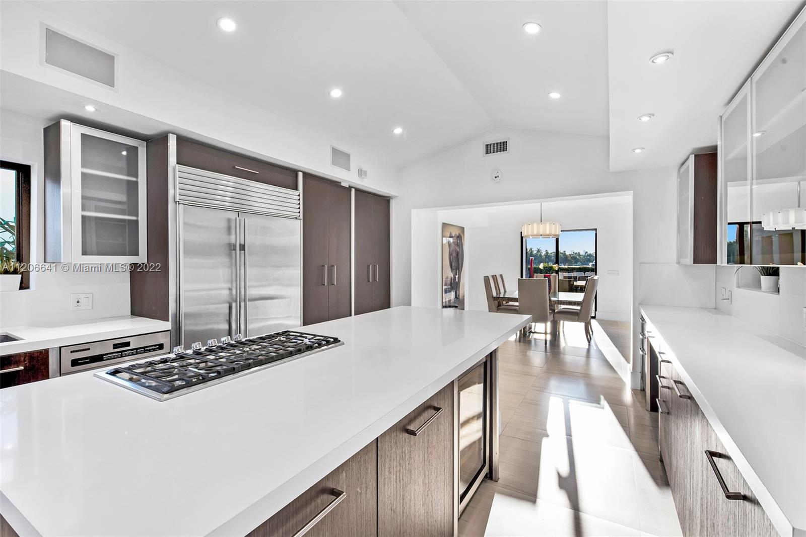 2700 North Bay Road Miami Beach, FL 33140 - Photo 14 of 42 a kitchen with kitchen island granite countertop a stove and a sink