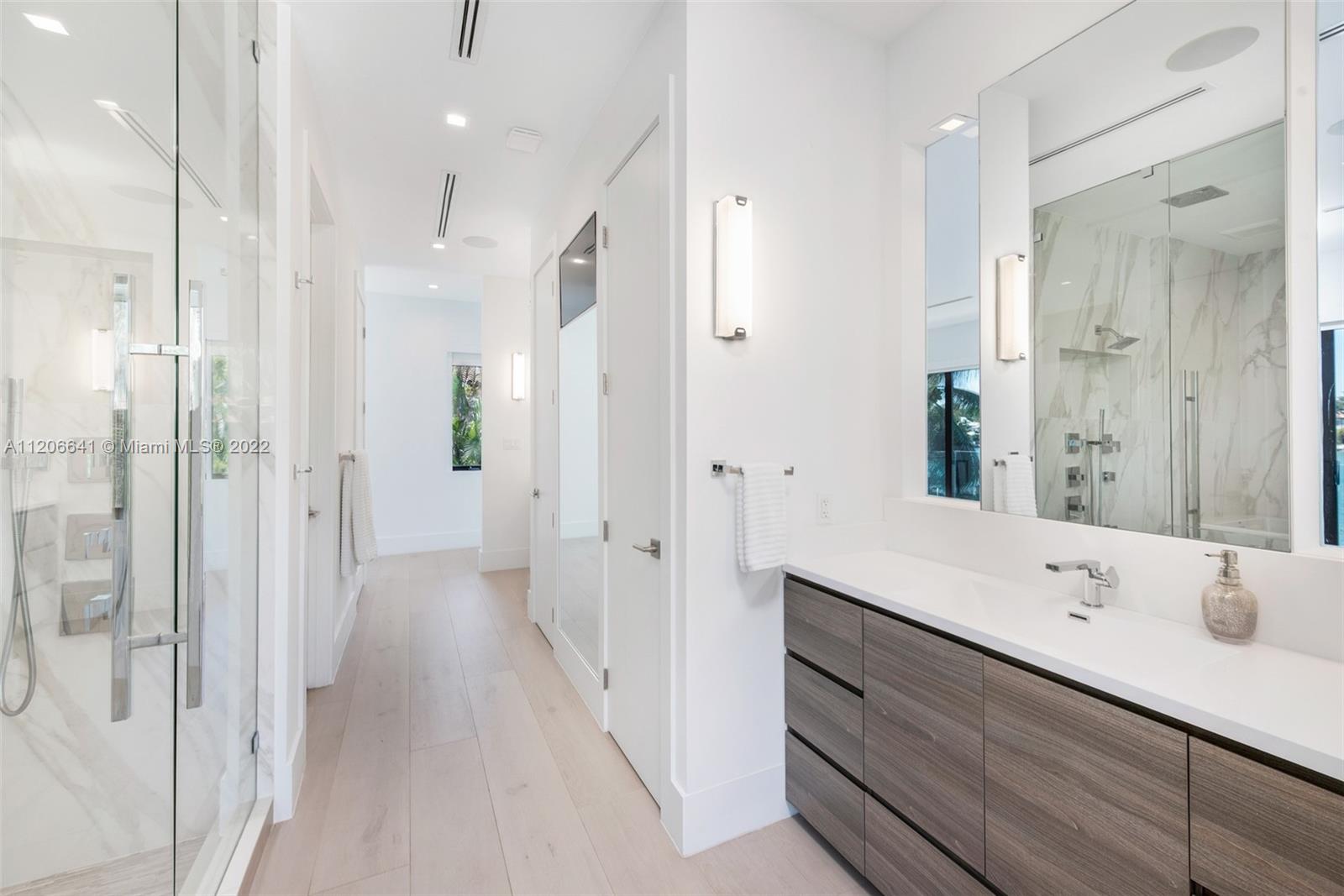 2700 North Bay Road Miami Beach, FL 33140 - Photo 17 of 42 a bathroom with a double vanity sink mirror and shower