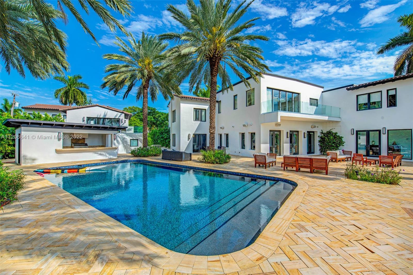 2700 North Bay Road Miami Beach, FL 33140 - Photo 2 of 42 a view of a house with swimming pool and sitting area