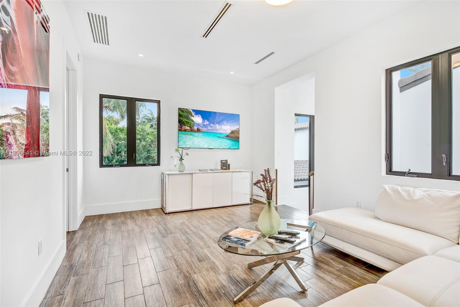 2700 North Bay Road Miami Beach, FL 33140 - Photo 23 of 42 a living room with furniture and a flat screen tv