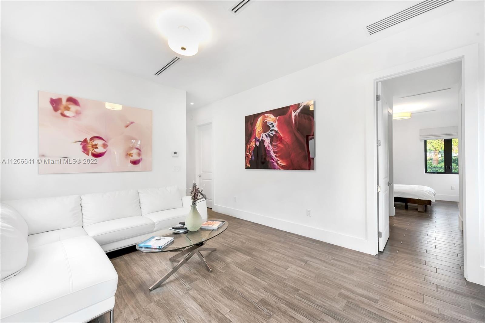 2700 North Bay Road Miami Beach, FL 33140 - Photo 24 of 42 a living room with furniture and a wooden floor