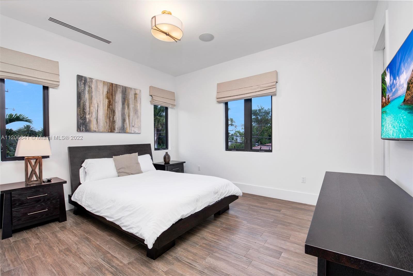 2700 North Bay Road Miami Beach, FL 33140 - Photo 32 of 42 a bedroom with a bed lamp and a window