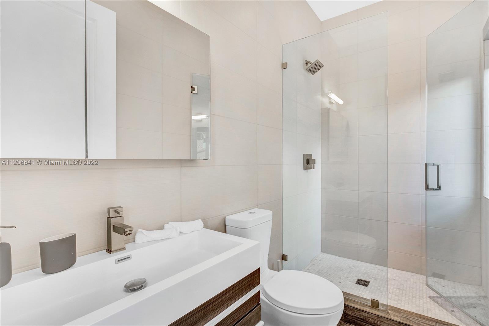 2700 North Bay Road Miami Beach, FL 33140 - Photo 34 of 42 a bathroom with a sink toilet and shower