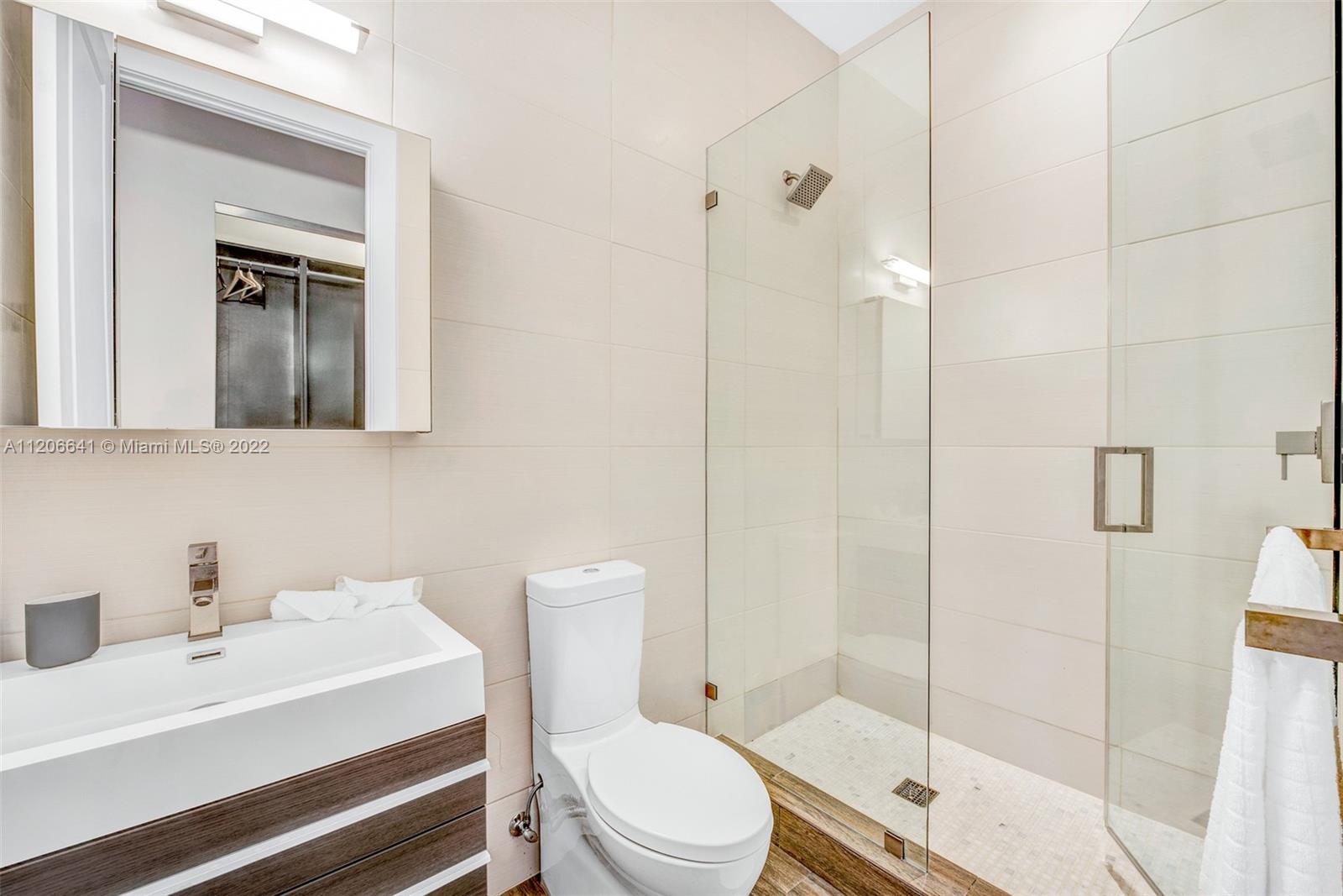 2700 North Bay Road Miami Beach, FL 33140 - Photo 36 of 42 a bathroom with a sink a toilet and shower