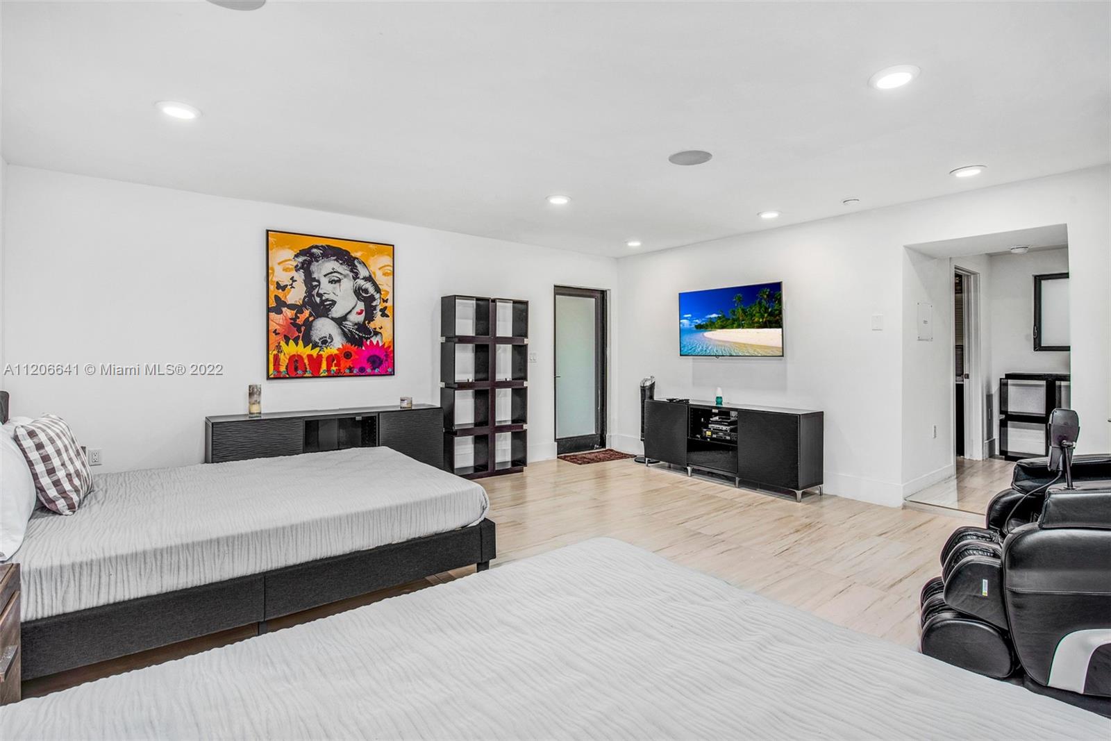 2700 North Bay Road Miami Beach, FL 33140 - Photo 38 of 42 a bedroom with furniture and a flat screen tv
