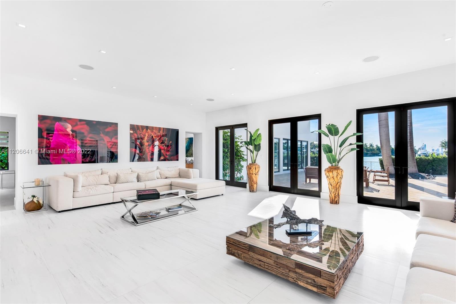 2700 North Bay Road Miami Beach, FL 33140 - Photo 4 of 42 a living room with furniture large window and flat screen tv