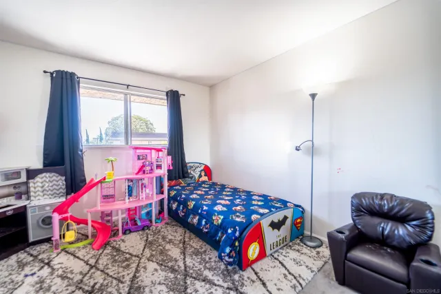 a bedroom with two beds and a window