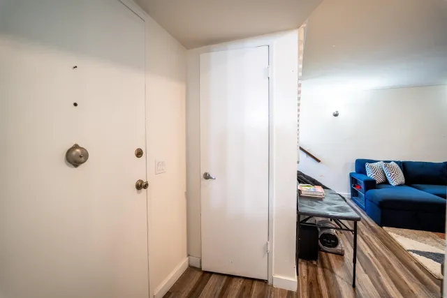 a view of a livingroom with furniture and hardwood floor