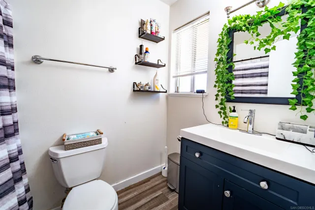 a bathroom with a toilet a sink and a window
