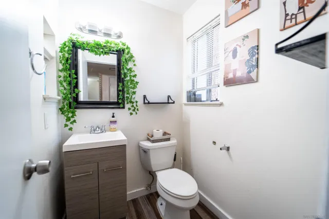 a bathroom with a toilet sink and mirror