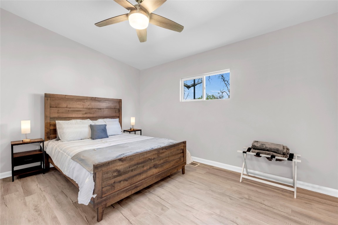 1946 Granite Cove Road Kingsland, TX 78639 - Photo 21 of 31 a bedroom with a bed and a chandelier