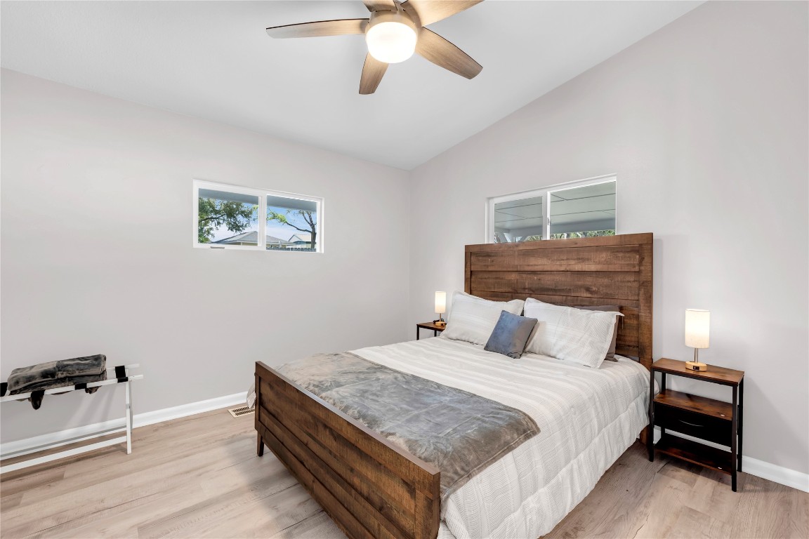 1946 Granite Cove Road Kingsland, TX 78639 - Photo 22 of 31 a bedroom with a bed and a chandelier
