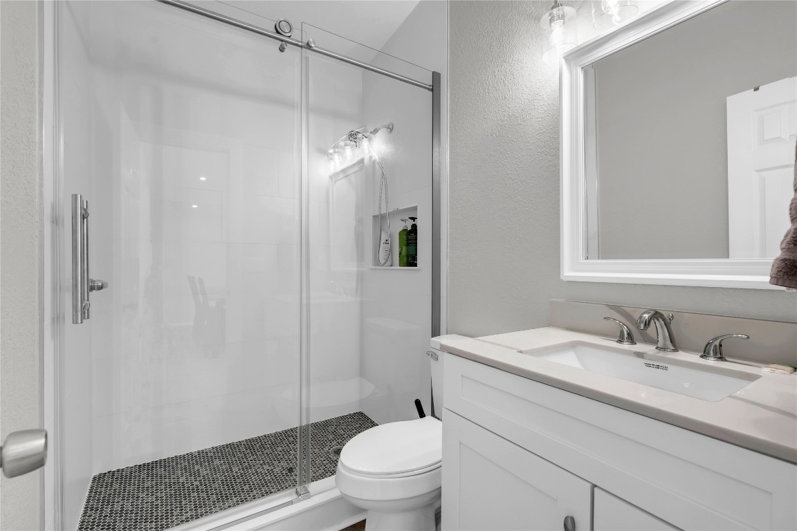 1946 Granite Cove Road Kingsland, TX 78639 - Photo 23 of 31 a bathroom with a sink toilet and shower