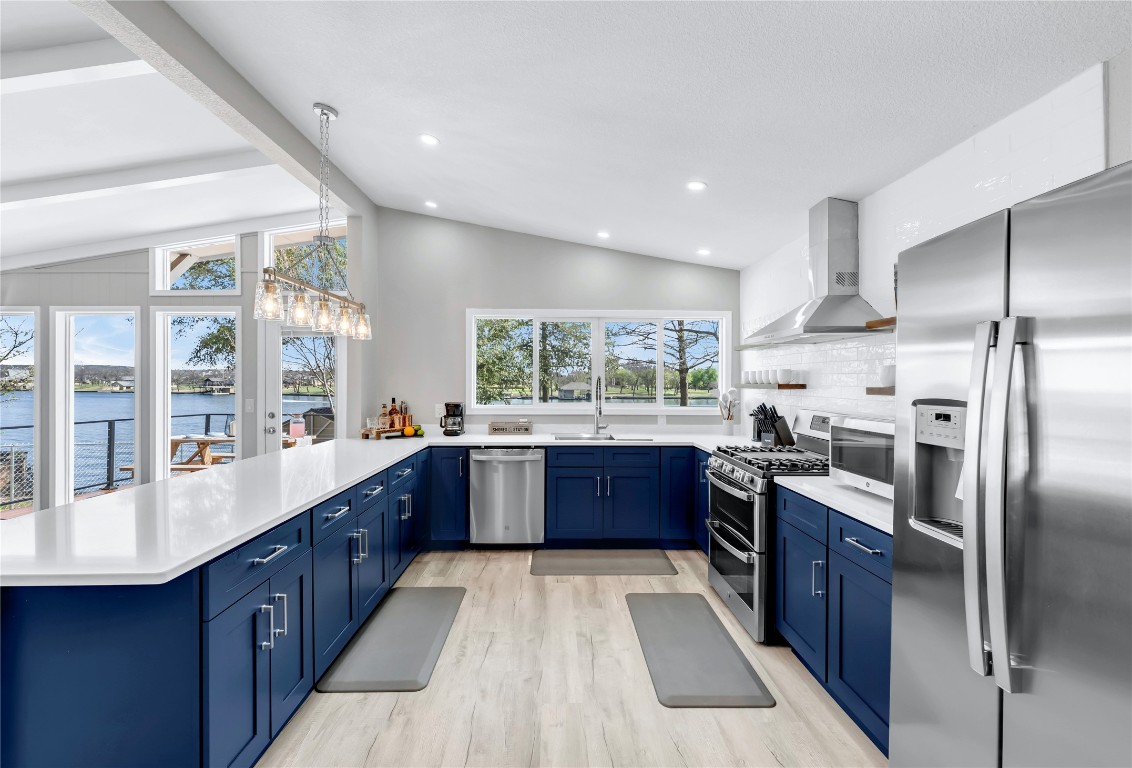 1946 Granite Cove Road Kingsland, TX 78639 - Photo 8 of 31 a large kitchen with stainless steel appliances kitchen island granite countertop a stove refrigerator and cabinets