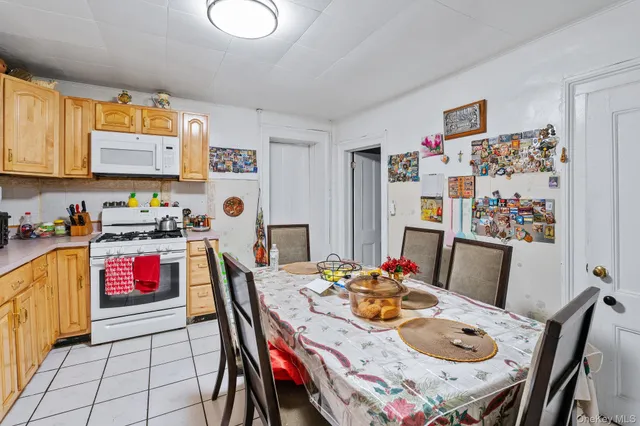 a view of dining room and kitchen with furniture wooden floor and a refrigerator
