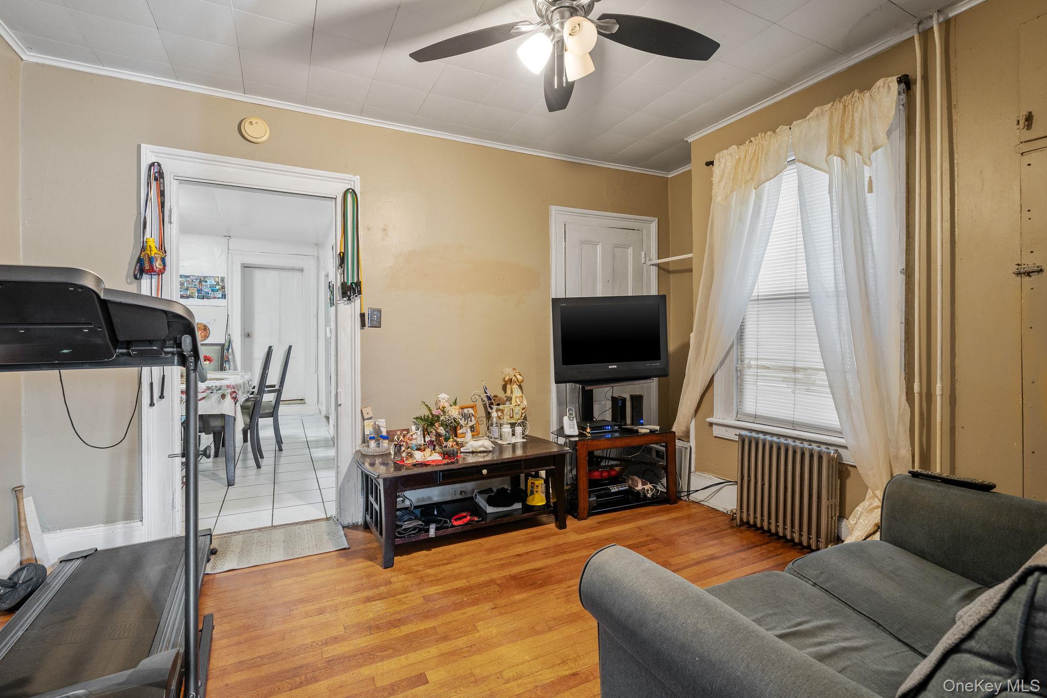 210 Renwick Street Newburgh, NY 12550 - Photo 4 of 6 a living room with furniture a flat screen tv and a table
