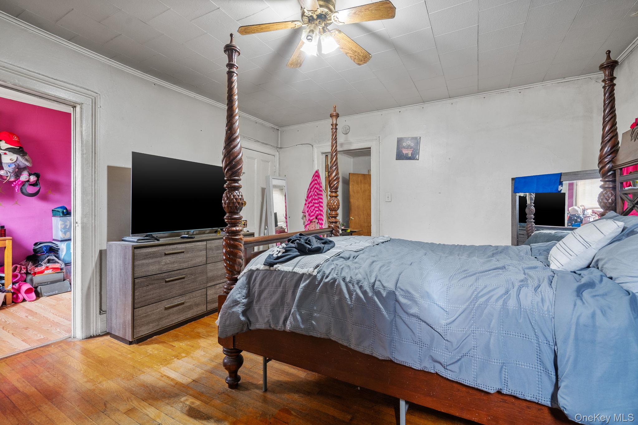 210 Renwick Street Newburgh, NY 12550 - Photo 5 of 6 a bedroom with a bed and a flat screen tv