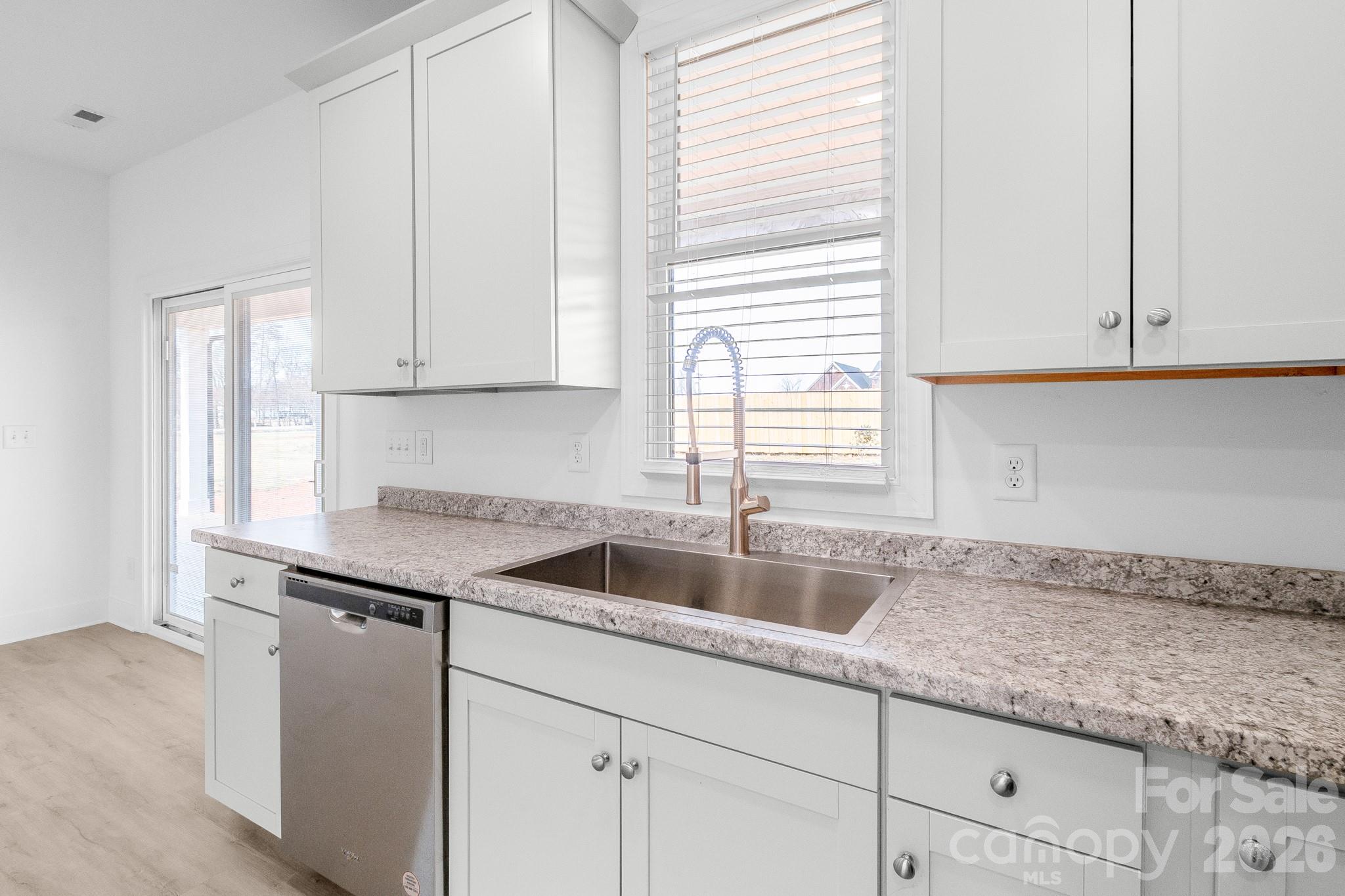 916 Fowler Road Monroe, NC 28110 - Photo 9 of 35 a kitchen with granite countertop a sink and a white cabinets