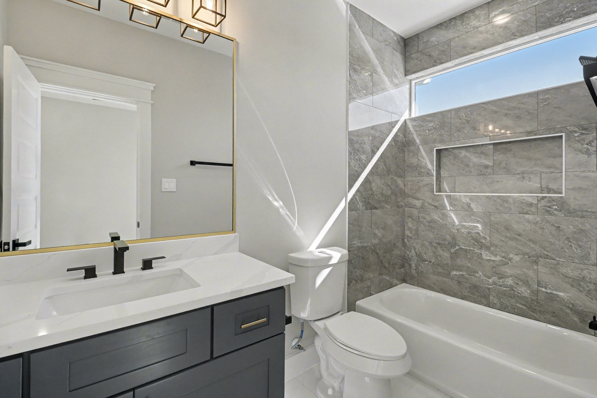5000 Higgins Street, Unit A Houston, TX 77033 - Photo 27 of 32 a bathroom with a sink a toilet and a large mirror