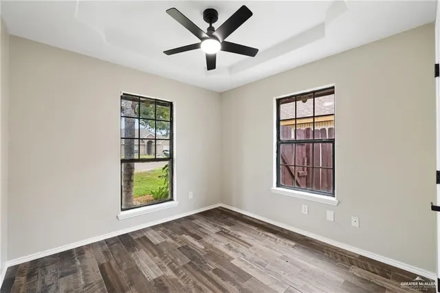 an empty room with windows and closet
