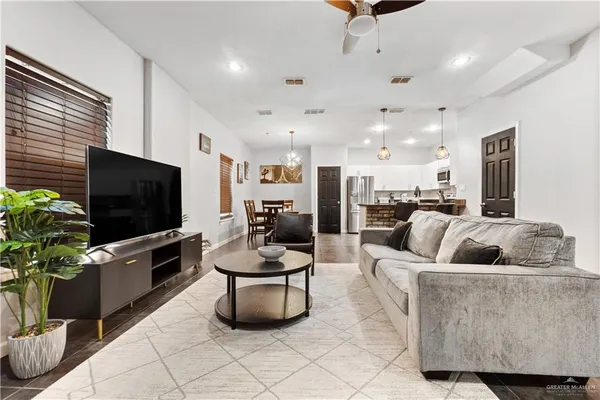 a kitchen with granite countertop a refrigerator and a sink