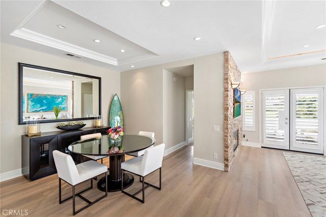 a dining room with furniture and wooden floor