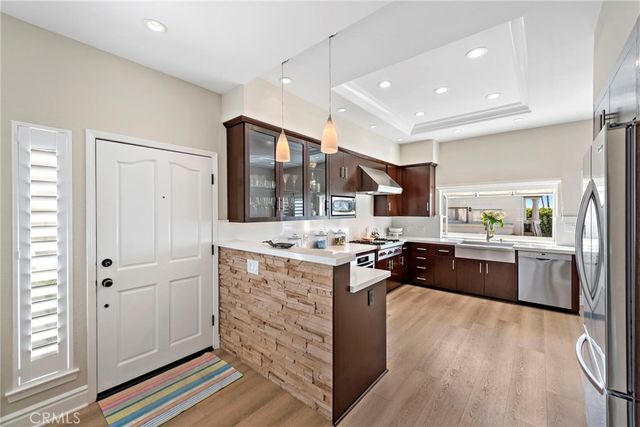 a kitchen with stainless steel appliances granite countertop a stove and a refrigerator