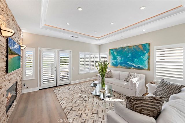 a living room with furniture a flat screen tv and a large window