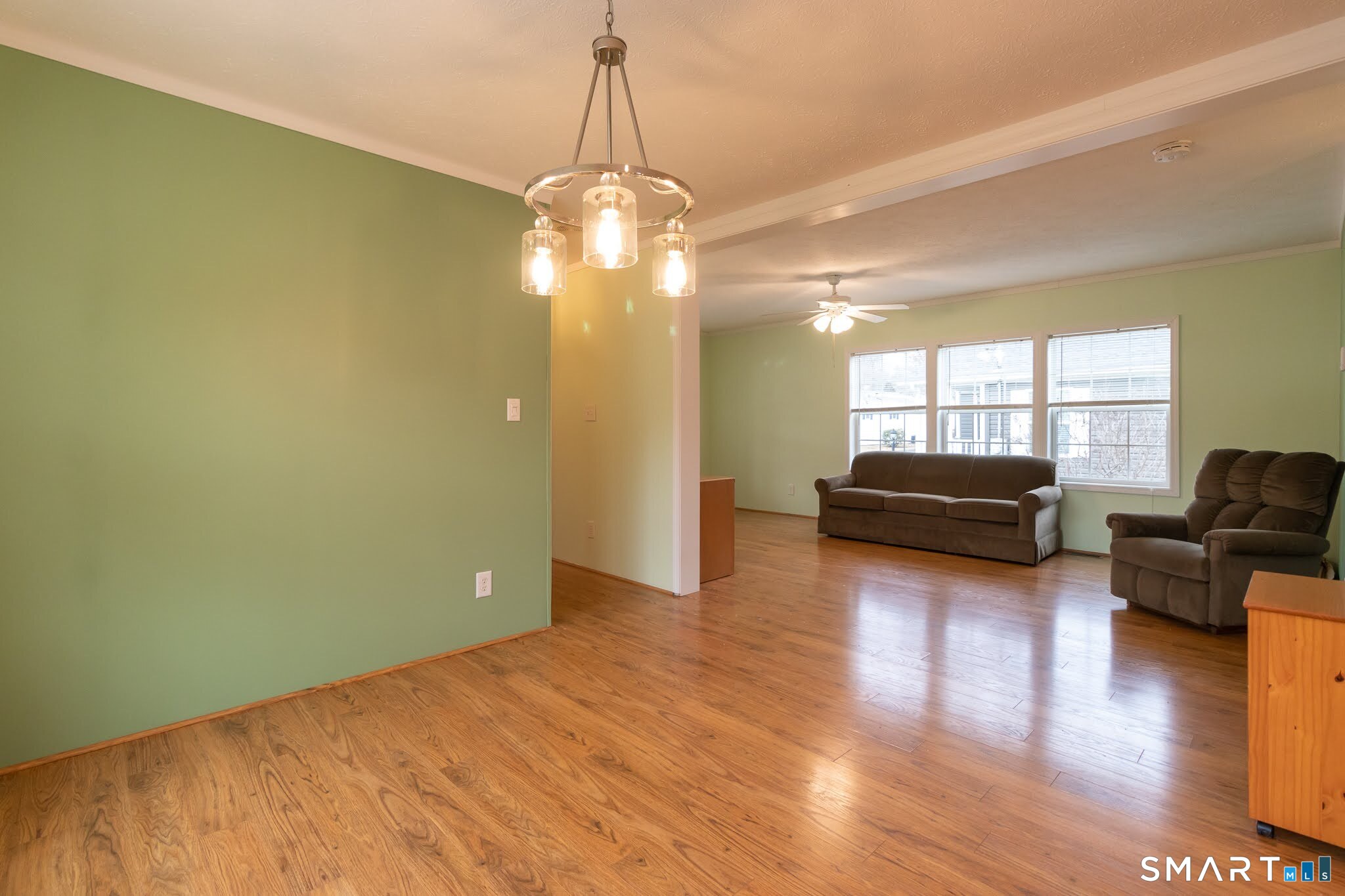 39 Riverside Drive Southington, CT 06489 - Photo 16 of 40 a view of a livingroom with furniture wooden floor windows and a chandelier