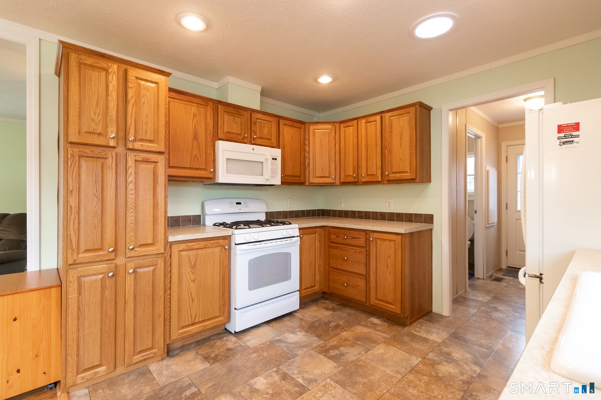 39 Riverside Drive Southington, CT 06489 - Photo 19 of 40 a kitchen with stainless steel appliances granite countertop a stove a sink and a refrigerator
