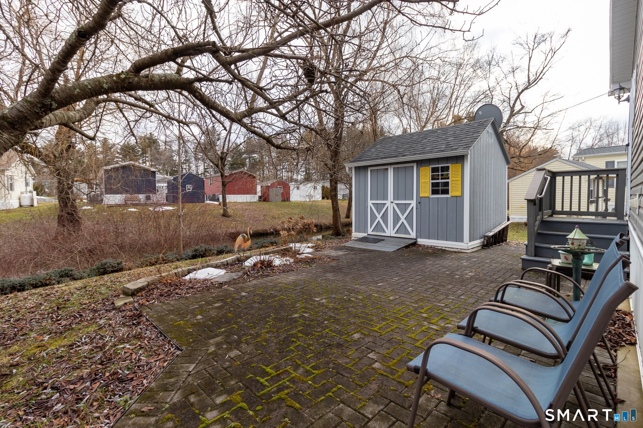 39 Riverside Drive Southington, CT 06489 - Photo 4 of 40 a backyard of a house with barbeque oven table and chairs