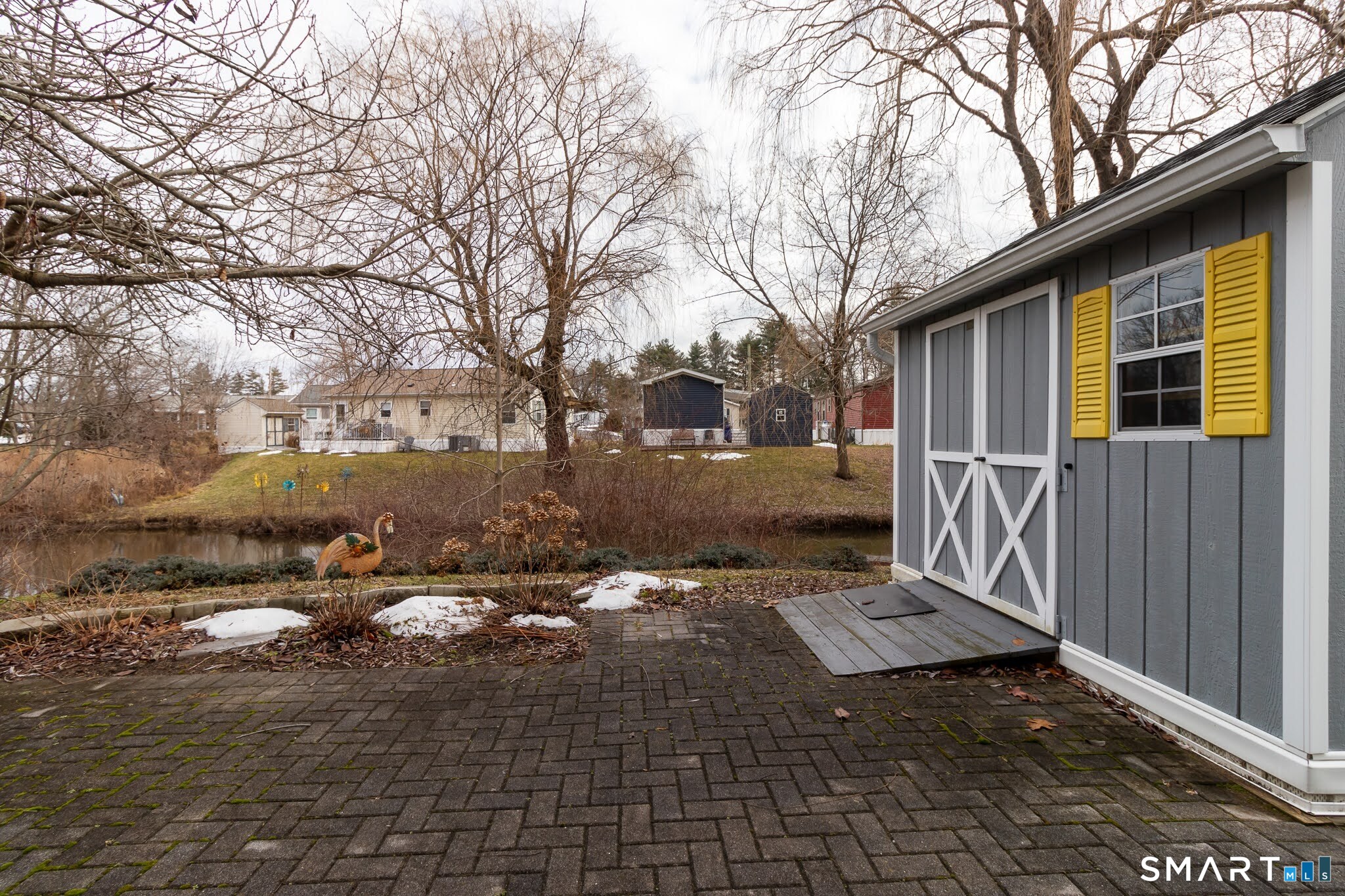 39 Riverside Drive Southington, CT 06489 - Photo 7 of 40 a backyard of a house with table and chairs