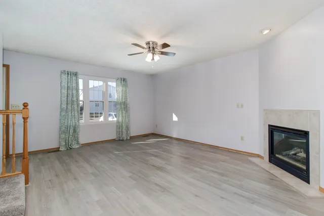 wooden floor in an empty room with a fireplace