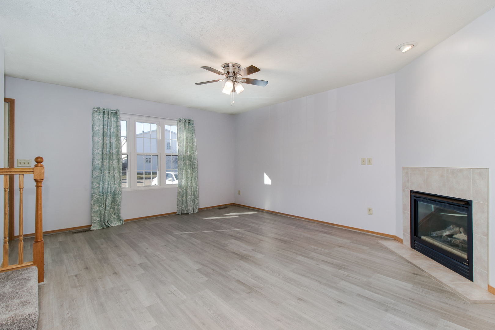 2 Andy Court, Unit 3 Bloomington, IL 61704 - Photo 3 of 13 wooden floor in an empty room with a fireplace