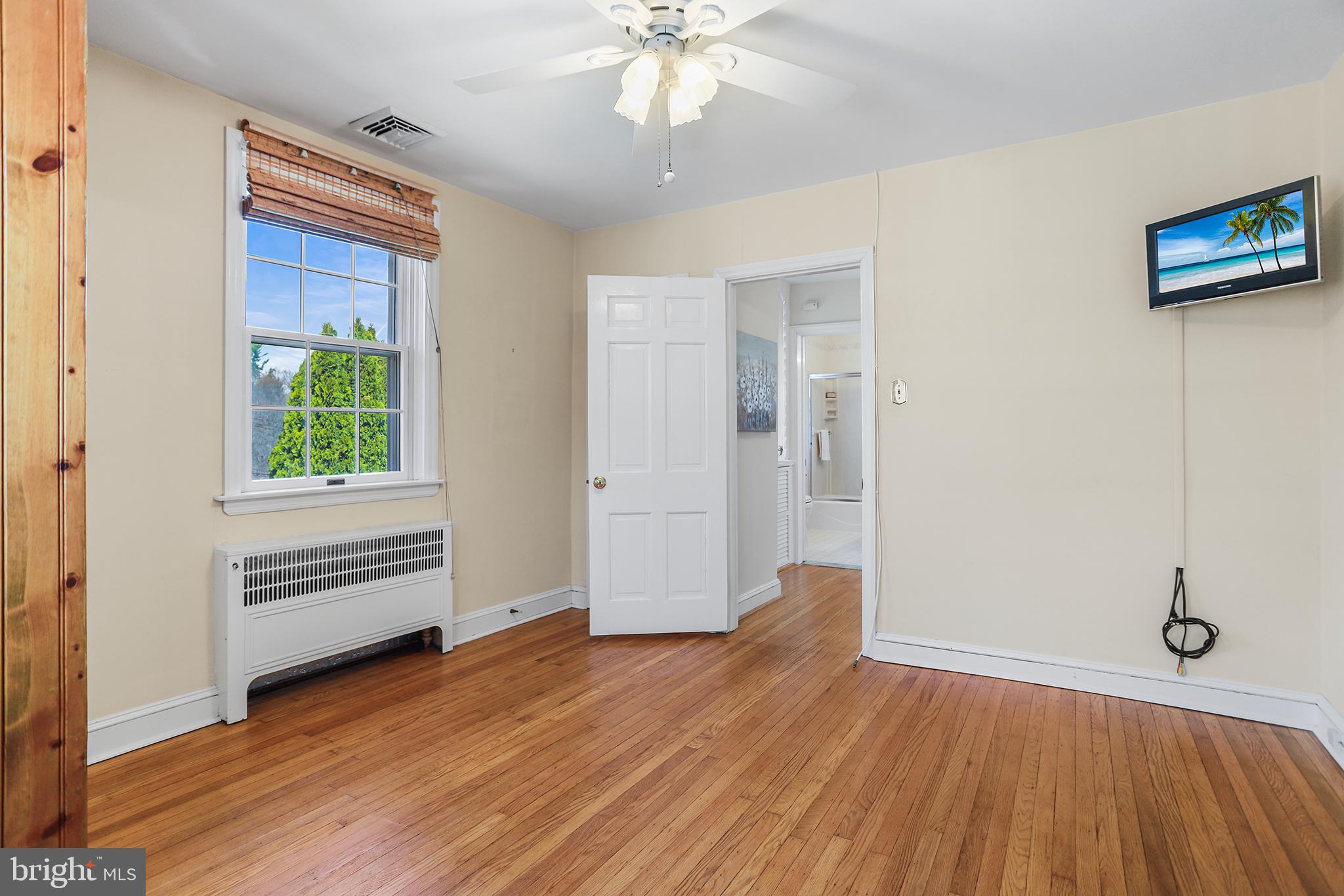 242 North Rolling Road Springfield, PA 19064 - Photo 22 of 37 wooden floor in an empty room with a window