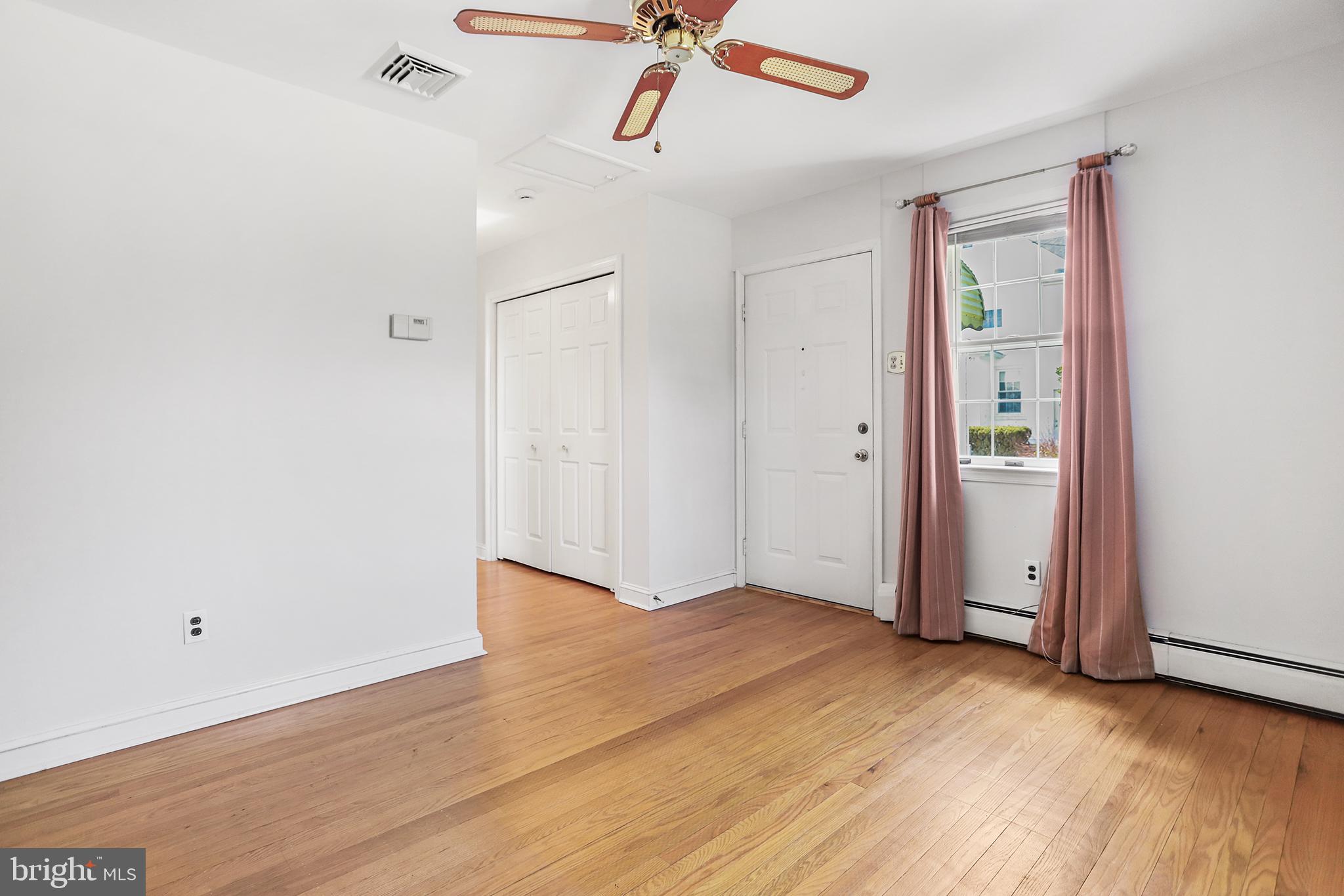 242 North Rolling Road Springfield, PA 19064 - Photo 25 of 37 an empty room with wooden floor cabinet and windows