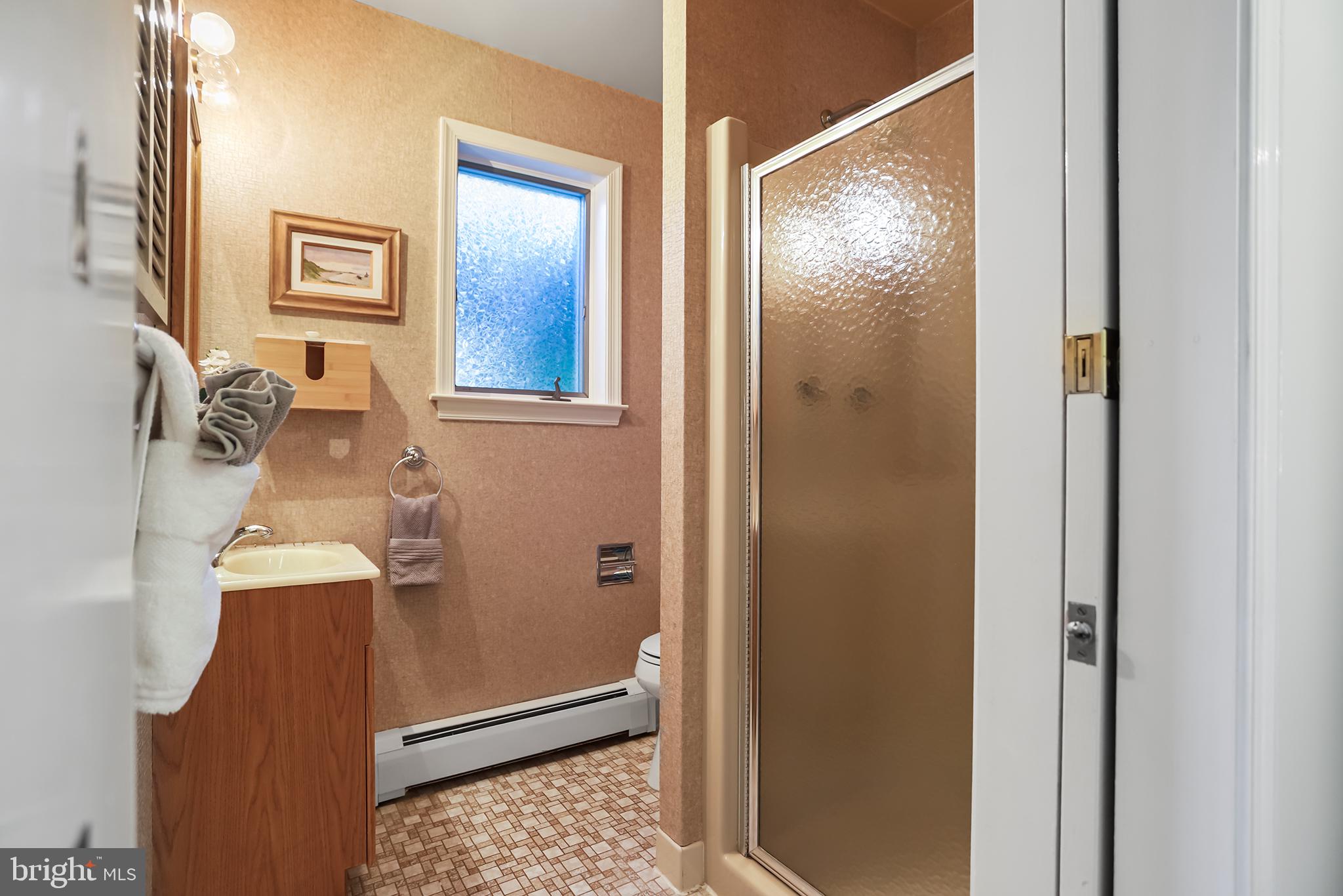 242 North Rolling Road Springfield, PA 19064 - Photo 27 of 37 a bathroom with a shower and a mirror
