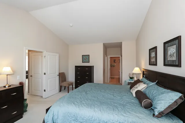 a spacious bedroom with a bed and a couch