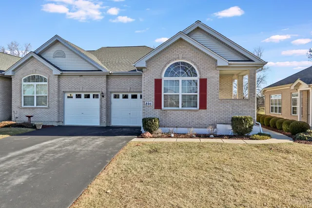 a front view of a house with large windows
