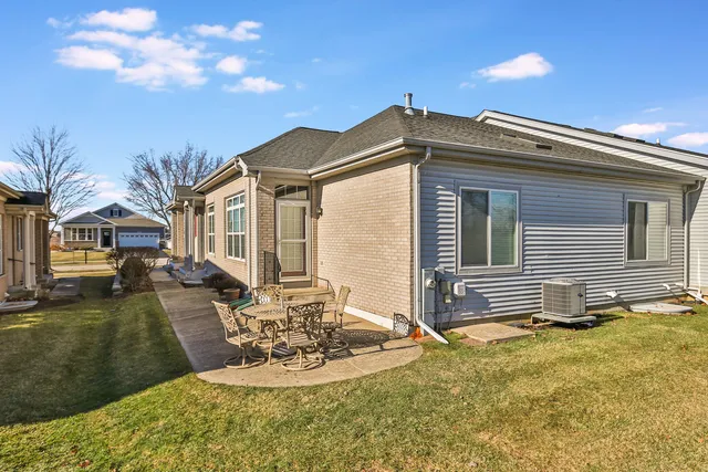 a view of a house with backyard and sitting area