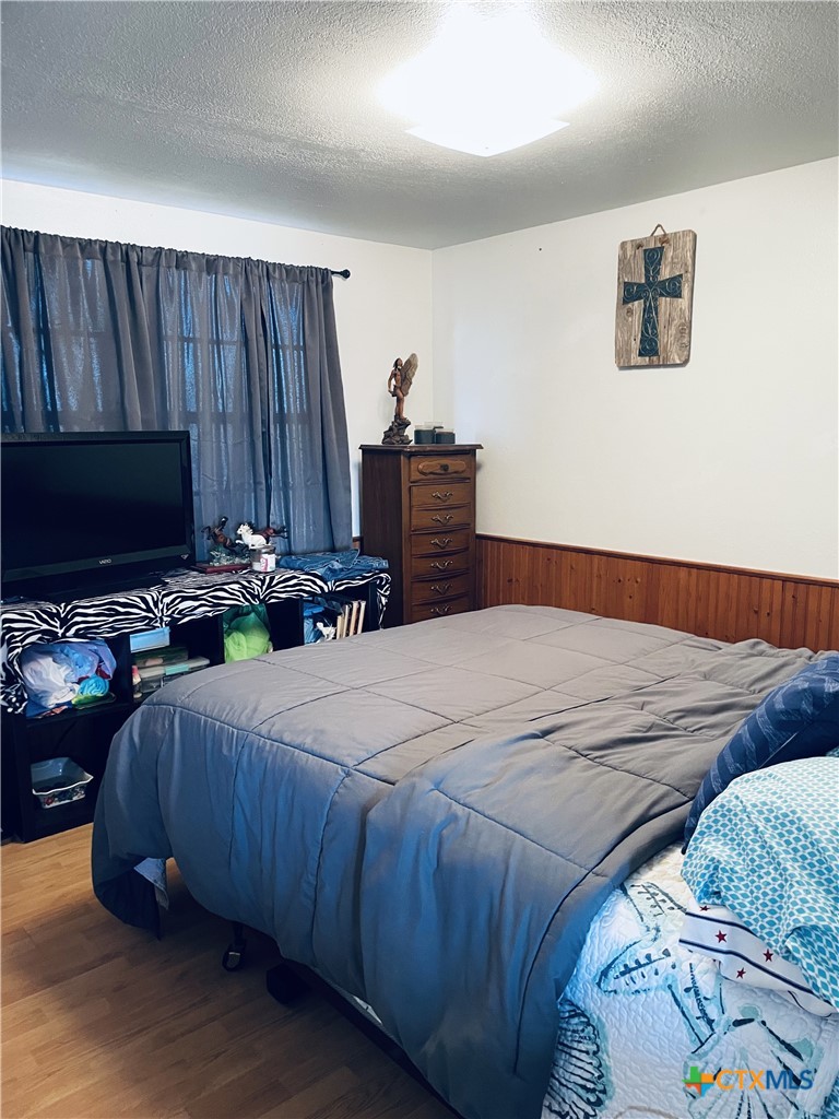 40 Cypress Valley Road Cuero, TX 77954 - Photo 12 of 24 a bedroom with a bed and a flat screen tv