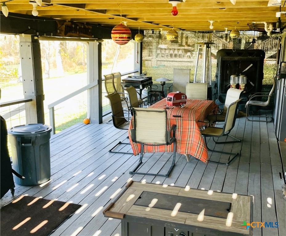 40 Cypress Valley Road Cuero, TX 77954 - Photo 16 of 19 a living room with furniture a flat screen tv and floor to ceiling window