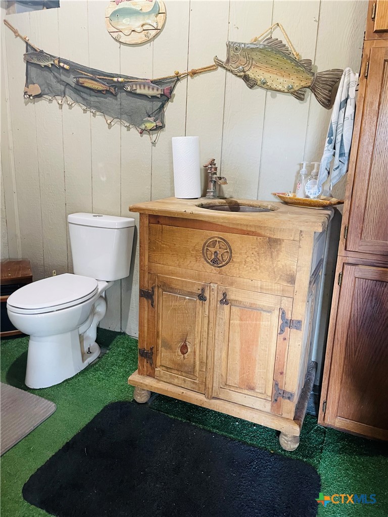 40 Cypress Valley Road Cuero, TX 77954 - Photo 22 of 24 a bathroom with a sink a toilet and a mirror