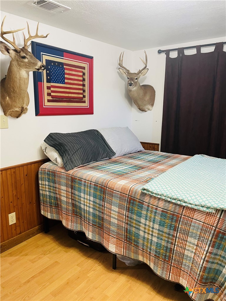 40 Cypress Valley Road Cuero, TX 77954 - Photo 24 of 24 a bedroom with a bed and dresser