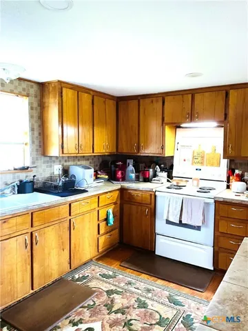 a kitchen with stainless steel appliances granite countertop a sink and a stove