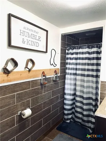 a living room with furniture a rug and a flat screen tv
