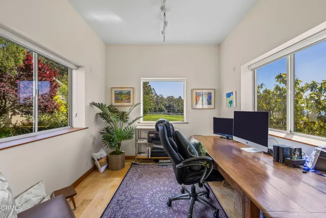 a view of a hallway with entryway wooden floor and front door