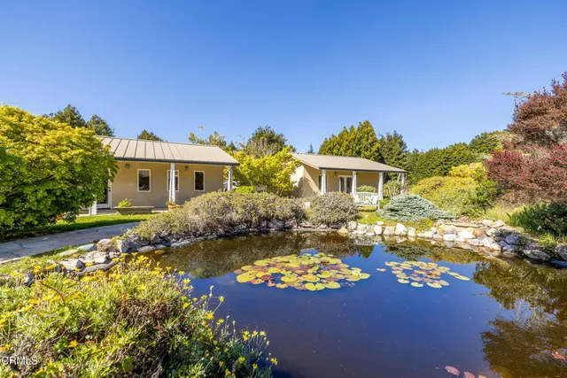 a large kitchen with stainless steel appliances granite countertop a sink and cabinets
