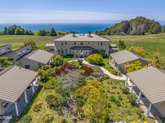 an aerial view of a house with a garden and swimming pool