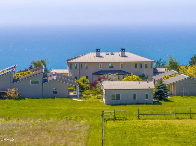 a view of a hallway with wooden floor and furniture